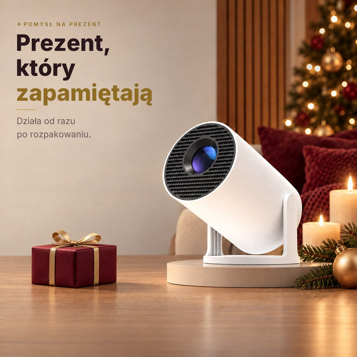 Projektor przenosny jako swiateczny prezent, obok zapakowane pudelko
